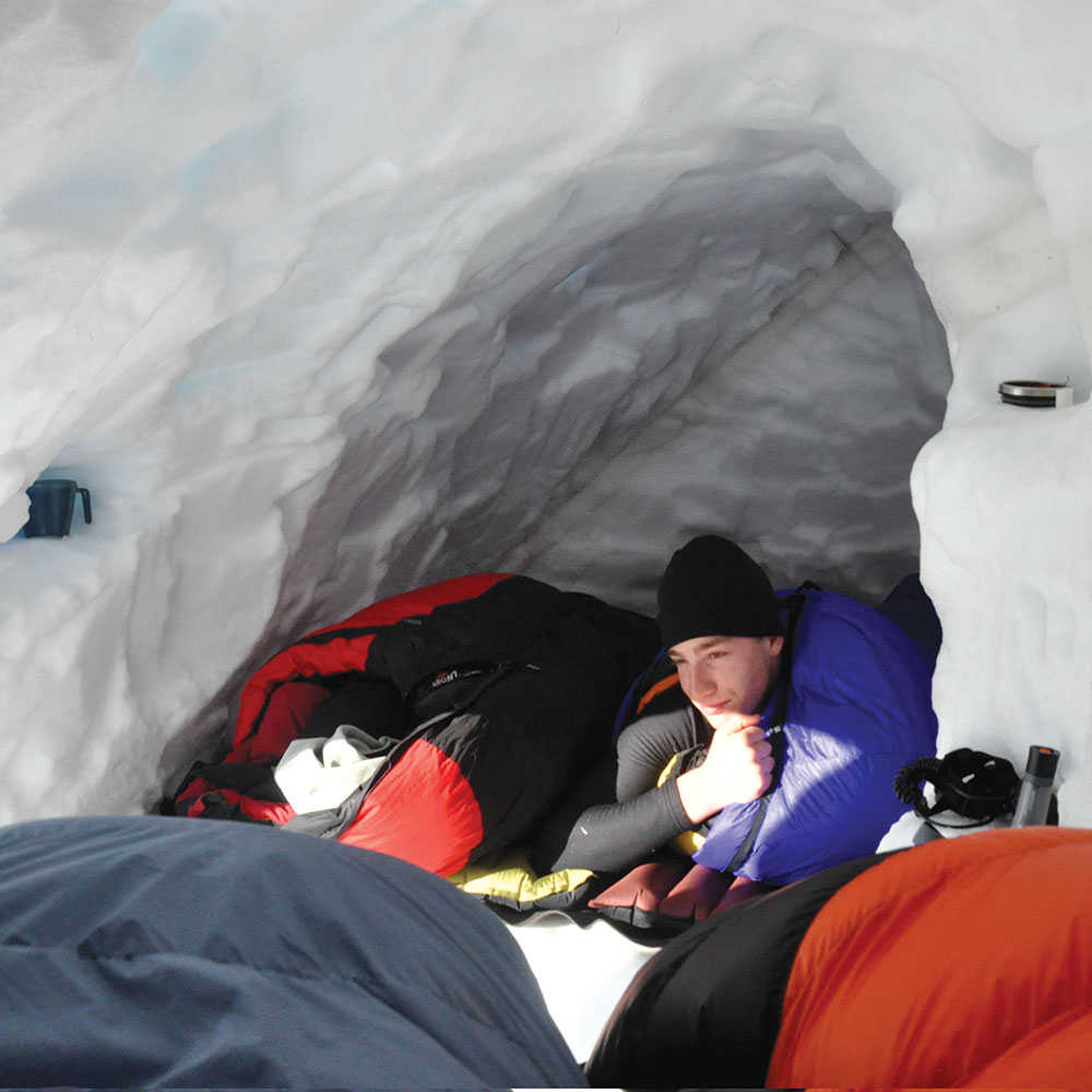 Josh staying warm in a snowcave in the Australia Snowys